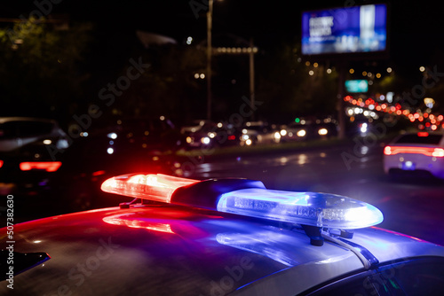 police car lights at night in city photo