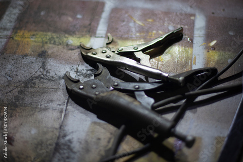 Clamps for supply of electricity to battery. Item in car repair shop. Parts of welding machine. photo