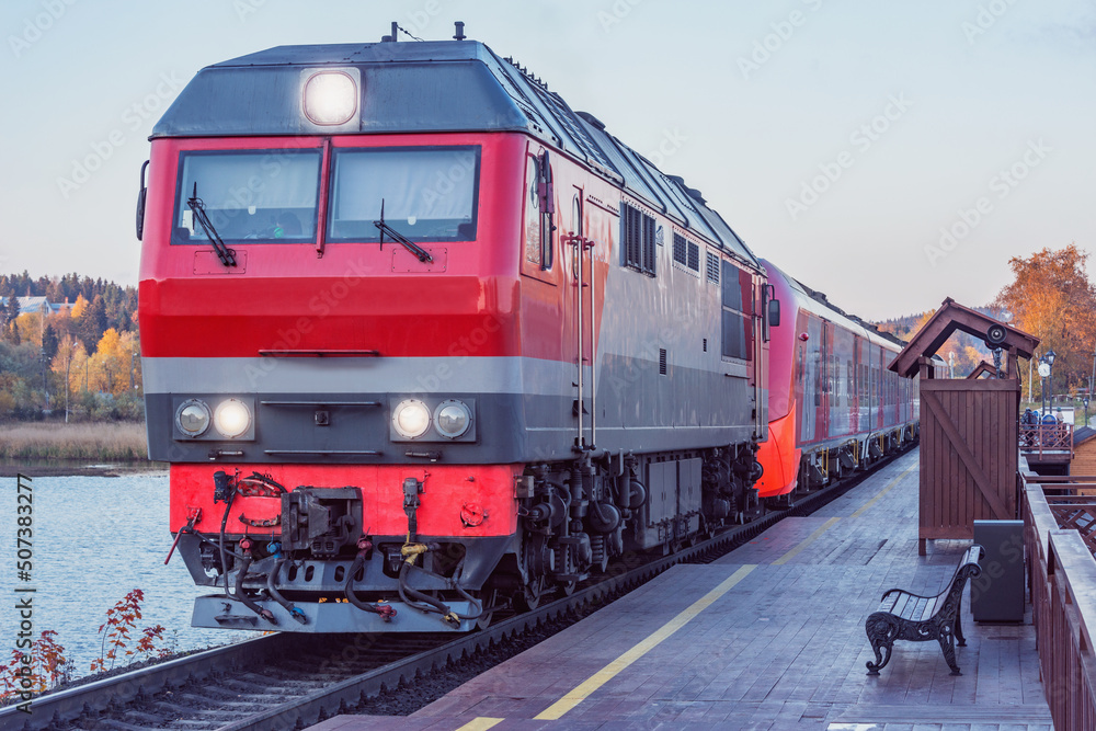 Highspeed train stands by the wooden platform at sunset. Sortavala. Republic of Karelia. Highspeed train stands by the wooden platform at sunset. Sortavala. Republic of Karelia.