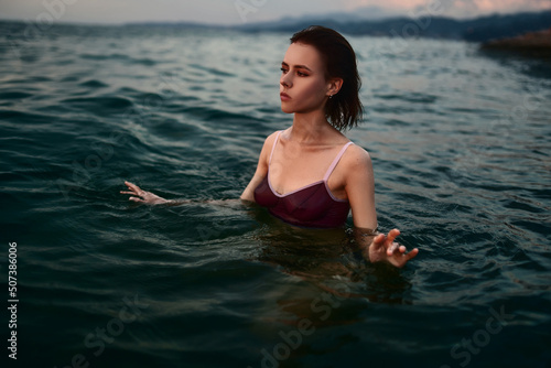 Attractive sexy lady is swimming in the sea. © Alex
