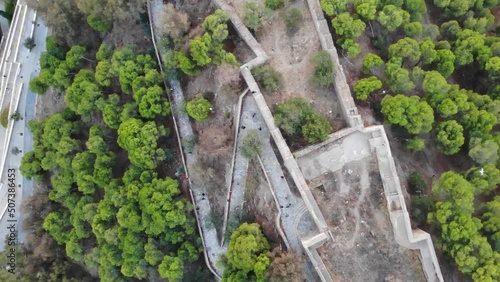Aerial Top View Of An Ancient Castle Walls Surrounded By Green Trees photo
