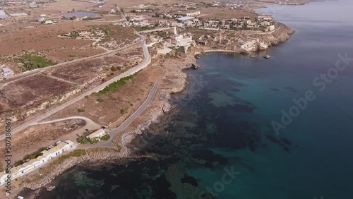 Aerial drone video. Footage of the rocky coastline and island at Portopalo di Capo Passero, Siracusa Province, Sicily.	 photo