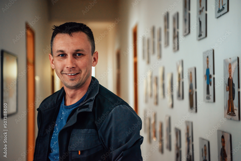 a portrait of a man in a work suit standing in the hallway of a factory a portrait of a man in a work suit standing in the hallway of a factory