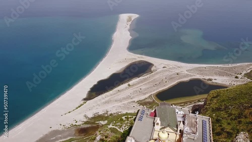 Drone aerial. Tindari Sanctuary on a cliff with views of the Aeolian Islands and the Patti gulf sea. The church hosts a statue of the black Madonna photo