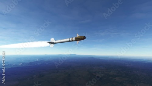 Guided missile flying above earth in low altitude. Realistic view of a high speed rocket hovering above ground and heading towards a target photo