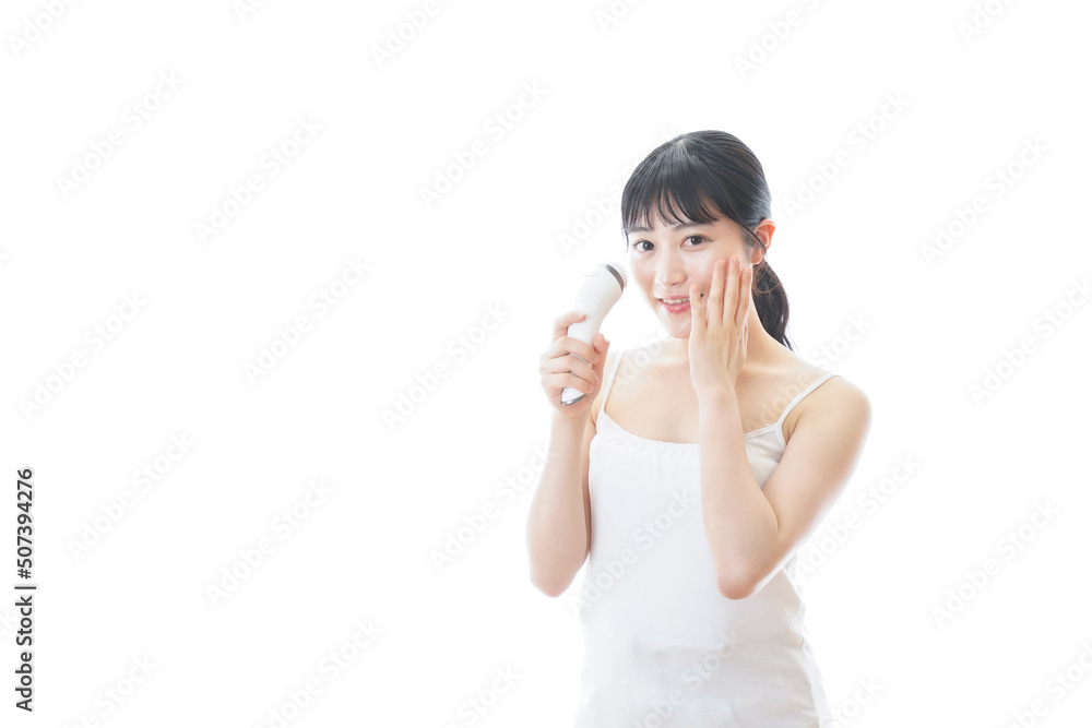 Young woman using a beauty equipment Young woman using a beauty equipment