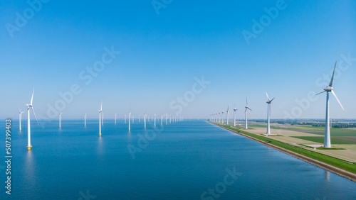 Tableau sur toile Windmill park in the ocean, drone aerial view of windmill turbines generating green energy electric, windmills isolated at sea in the Netherlands