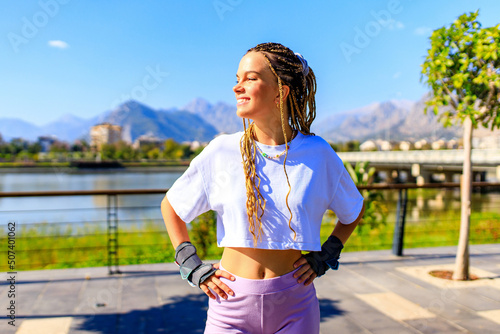 Protective skate safety concept , woman with equipment in beach and mountain background on a summer day