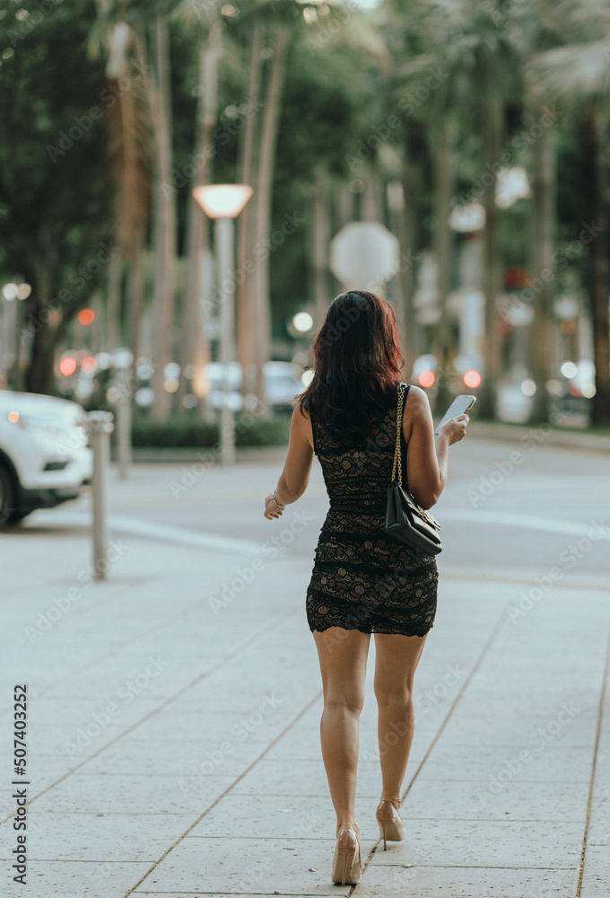 woman walking on the street phone shopping fashion model latin 