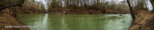 green river flowing through the forest in winter