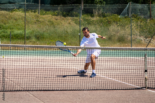 Tennis player performing a drop shot photo