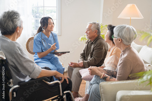 Vászonkép Group of Asian senior people sit in a circle in a nursing home and listen to nurse during a group elderly therapy session