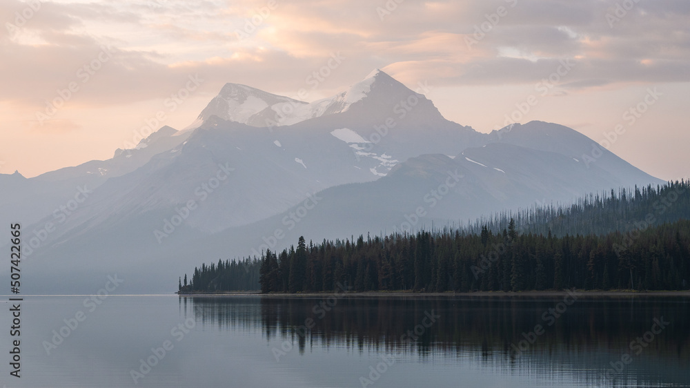 Colorful sunrise with peaceful lake and prominent mountain in the background , Jasper NP, Canada