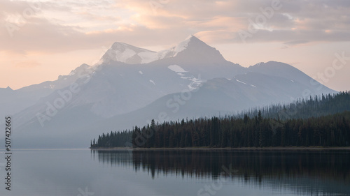 Colorful sunrise with peaceful lake and prominent mountain in the background   Jasper NP  Canada