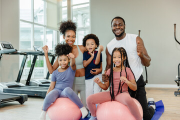 healthy black family children and parent exercise activity healthcare together at fitness sport club.