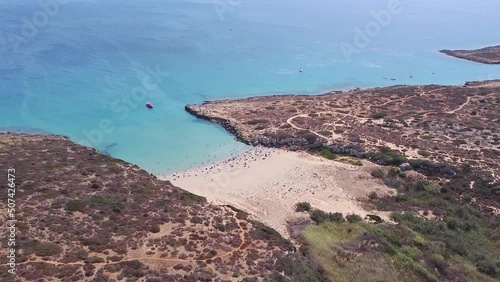 Aerial drone. Crystal clear turquoise waters at Calamosche, one of the most beautiful beaches in Sicily. Vendicari nature reserve near Noto, Siracusa. photo