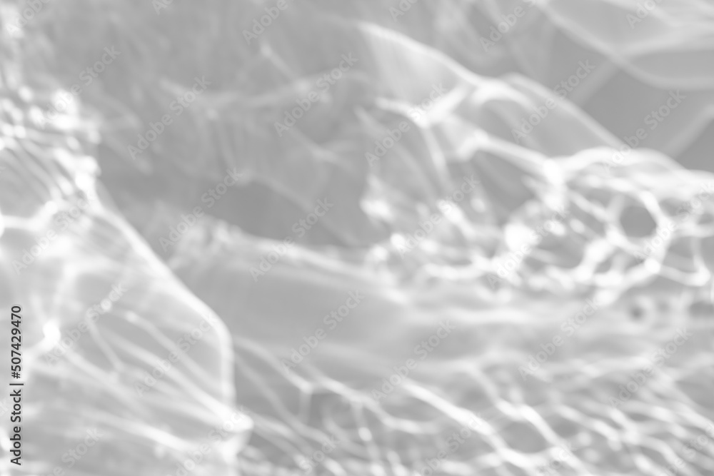 Blurred defocused water texture overlay effect for photo and mockups. Organic drop diagonal shadow and light caustic effect on a white wall. Shadows for natural light effects Blurred defocused water texture overlay effect for photo and mockups. Organic drop diagonal shadow and light caustic effect on a white wall. Shadows for natural light effects