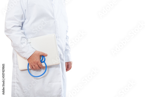 A male doctor stands with a laptop and a stethoscope