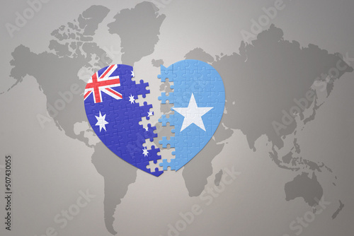 puzzle heart with the national flag of somalia and australia on a world map background. Concept.