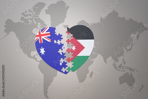 puzzle heart with the national flag of jordan and australia on a world map background. Concept.