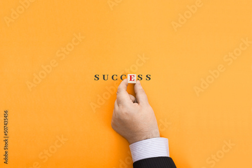 Fototapeta Businessman makes the word Success