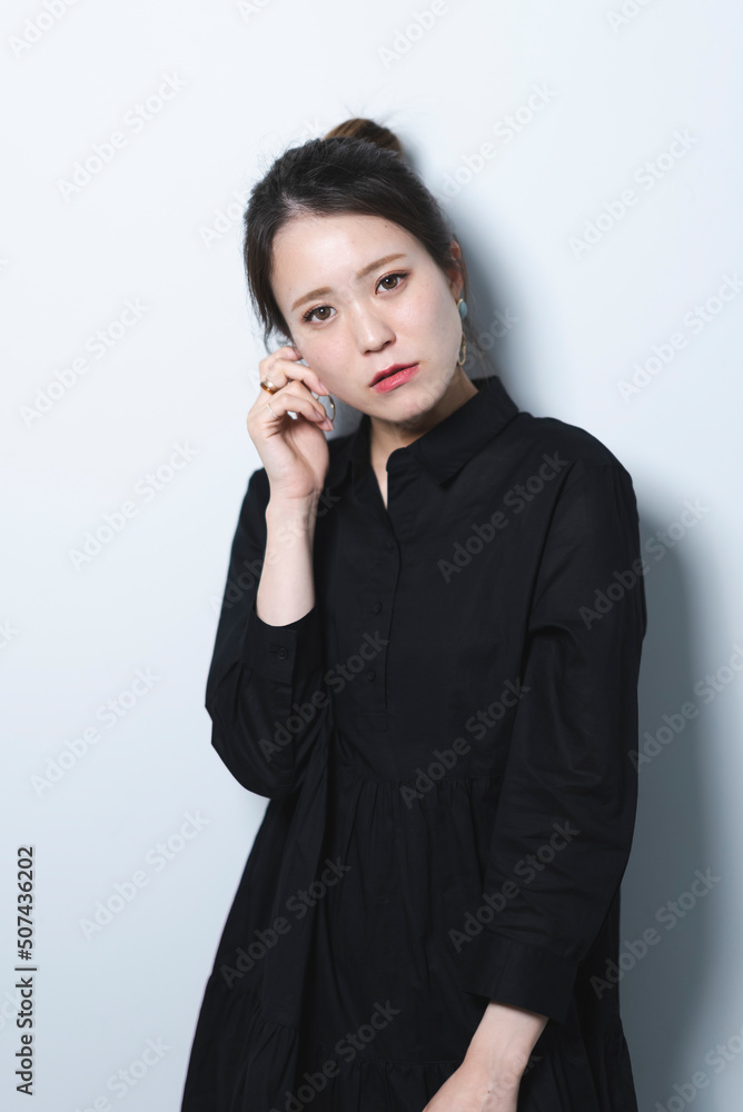 黒いワンピースを着たクールな女性