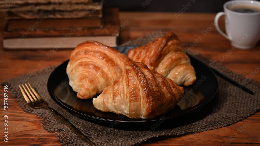 Homemade butter croissants on wooden table with coffee cup for breakfast