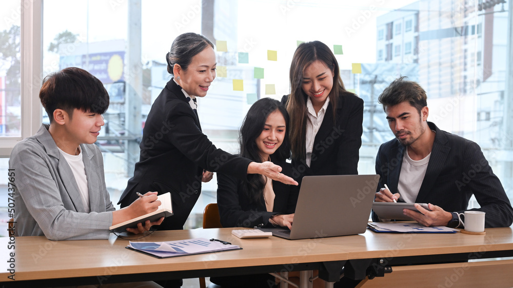 Shot of middle aged female team leader explaining project details, discussing for new strategy of development to diverse employees in meeting Shot of middle aged female team leader explaining project details, discussing for new strategy of development to diverse employees in meeting