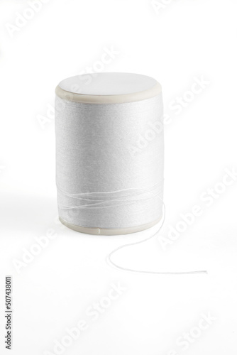 white sewing thread spool on a white.