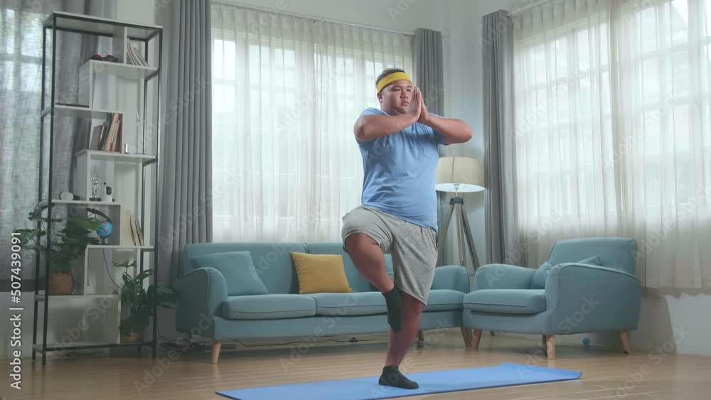 Fat Asian Man Doing Yoga In Tree Pose On Mat At Home
Fat Asian Man Doing Yoga In Tree Pose On Mat At Home