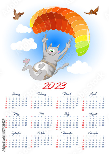 Wall calendar 2023 with a cartoon cat enjoying paragliding on a colorful parachute. 12 months on one sheet
