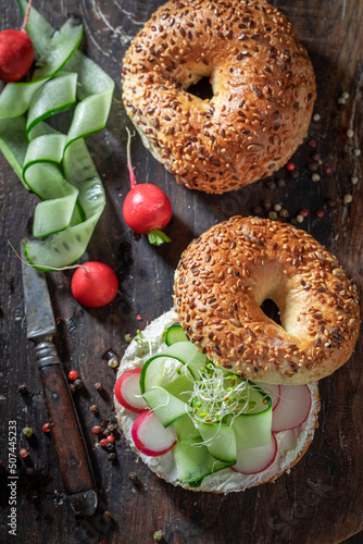 Delicious and healthy golden bagel with cottage cheese and cucumber.