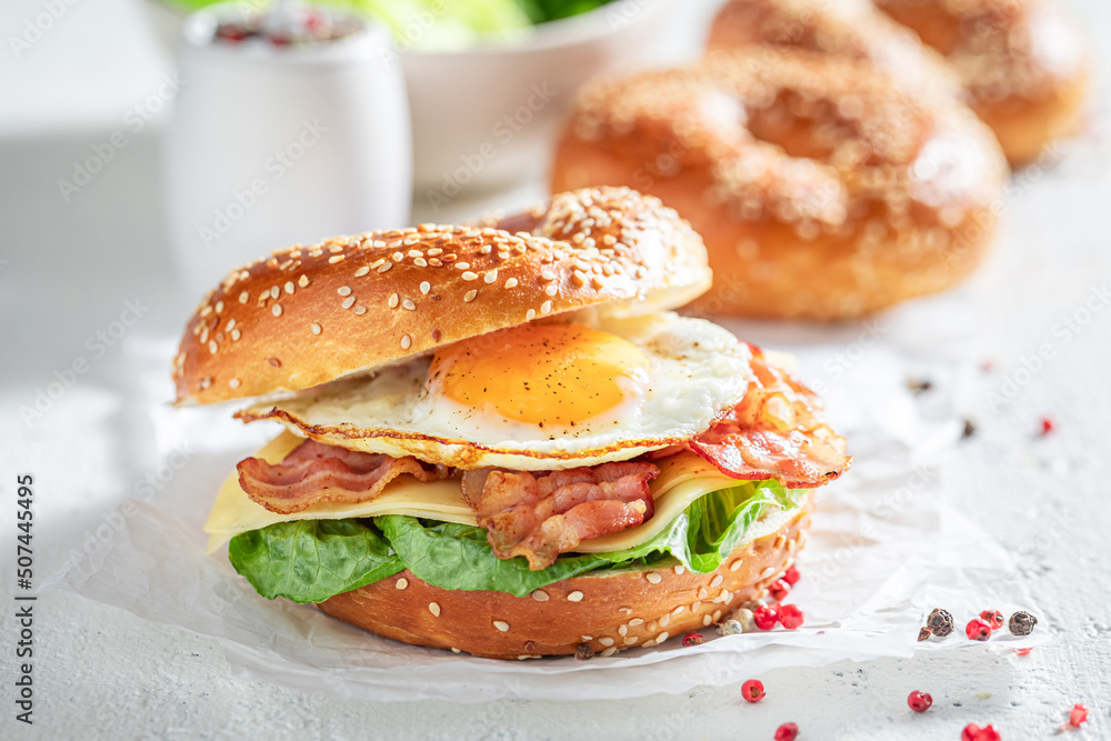 Healthy and tasty bagels with bacon and fried egg. Healthy and tasty bagels with bacon and fried egg.