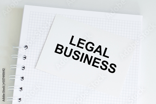 Legal business text card on the background of an empty snack on the table, business concept
