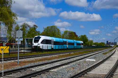 Railway lines and modern train on sunny day