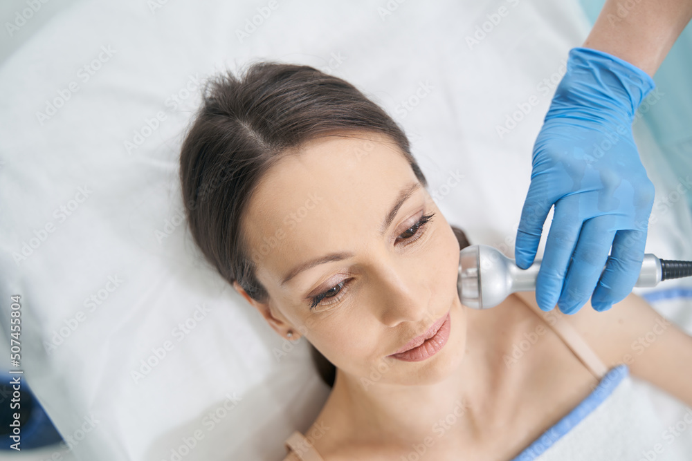 Top view of cheek rejuvenation treatment with radiofrequency lifting Top view of cheek rejuvenation treatment with radiofrequency lifting