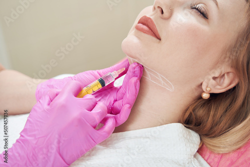 Quadro su tela Elegant Caucasian female is getting injection for smoothing of neck wrinkles