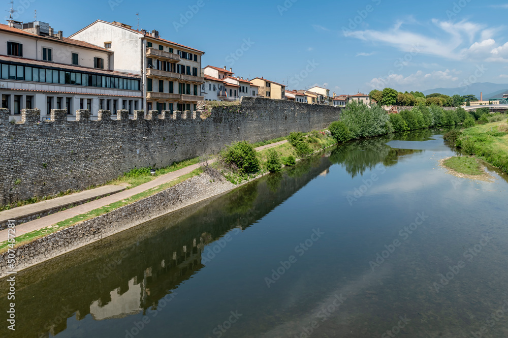 The path along the Bisenzio river in the old town of Prato, Italy, on a sunny day
