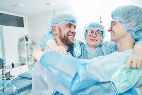 Successful surgical team embracing in surgery theater