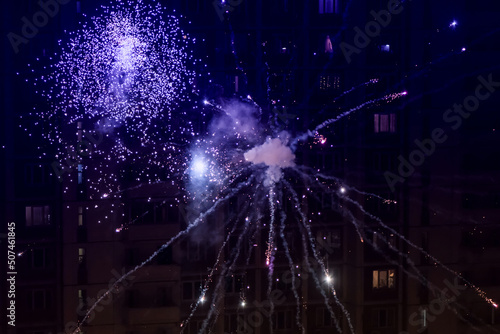 Photography Colorful closeup fireworks light up on the windows of a residential building background
