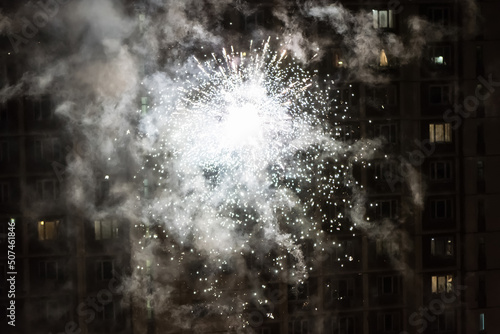 Photography Colorful closeup fireworks light up on the windows of a residential building background