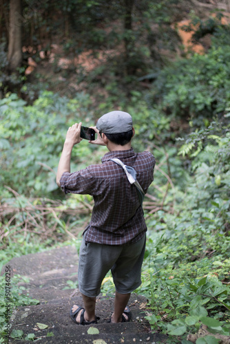 One person taking selfies in the forest concept, travelling alone, taking selfies.