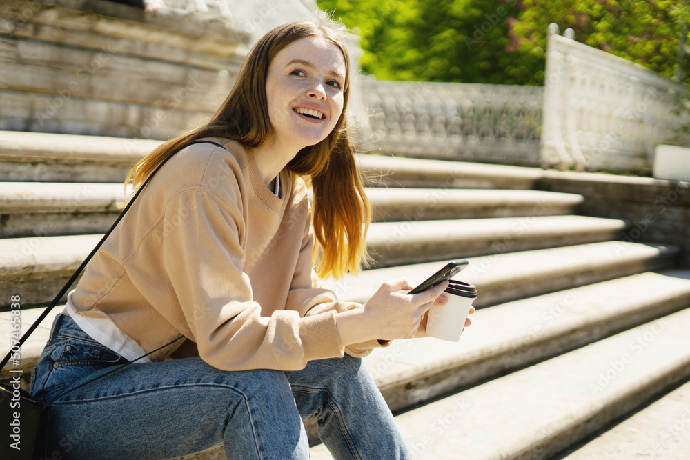 A female blogger uses her phone to write a message on a social network. A female blogger uses her phone to write a message on a social network.