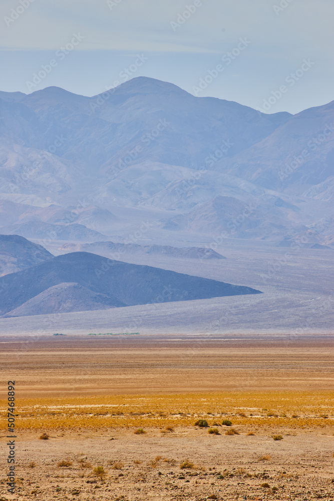 Death Valley desert layers of colorful plains and large mountains