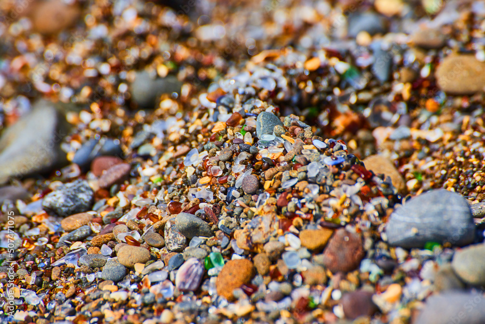 Detail of beach filled with colorful and shiny glass pieces Detail of beach filled with colorful and shiny glass pieces