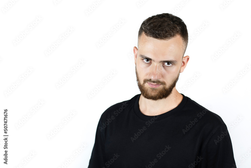 The young man is sad on a light background, he is a little angry because his business partners set him up, let him down, now the guy is failing in business The young man is sad on a light background, he is a little angry because his business partners set him up, let him down, now the guy is failing in business