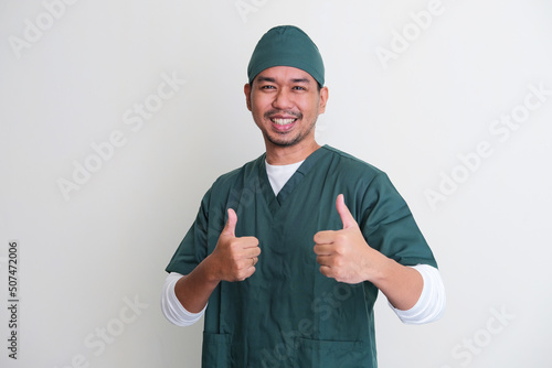 Asian hospital nurse smiling and giving two thumbs up photo