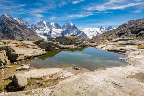 Fototapeta Naklejka Na Ścianę i Meble -  Fuorcla Surlej is a mountain pass in the Swiss Alp (connecting the Upper Engadine Valley with Roseg Valley) with stunning views on the Bernina Massif. There is also a small lake and a mountain hut.