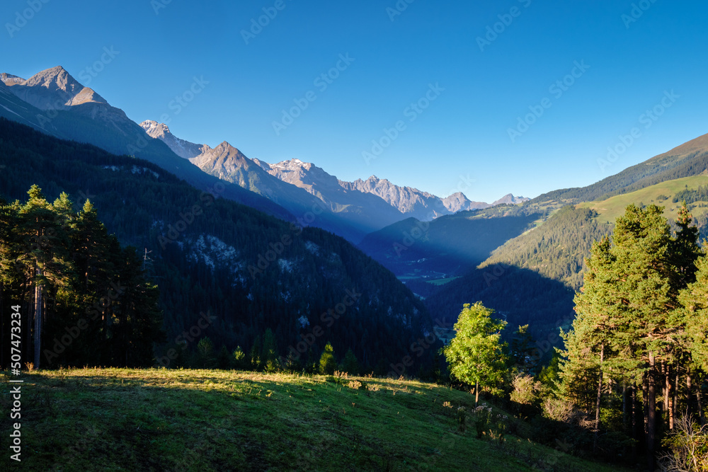 The sun is rising on a autumn morning at mountain pass Norbertshöhe (Tyrol, Austria), that offers a gorgeous view into the Swiss Lower Engadine Valley. It's near the Austria-Switzerland border.