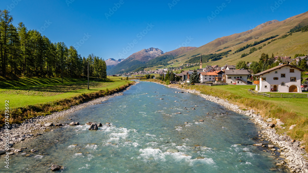 The village of S-Chanf, located in the Upper Engadine Valley (Grisons, Switzerland), as seen from the stone Inn Bridge (Inn Brücke) over the river Inn. It's located near the Swiss National Park.